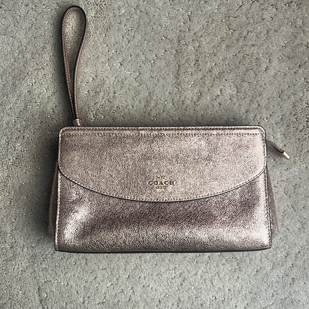 NWT Coach metallic rose gold clutch with wrist strap